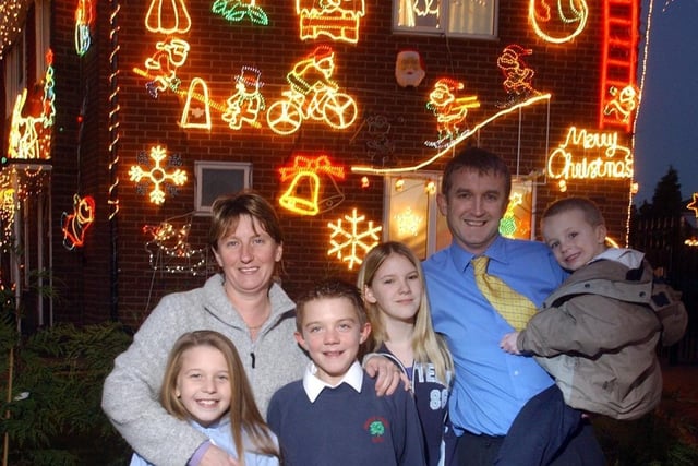 Families on Windermere Drive in Garforth who decorated their houses with Christmas lights from charity in 2003. Pictured are June Rollins (left) with children Jade and Thomas, and Nigel Burton-Power with children Joshua and Charlotte.