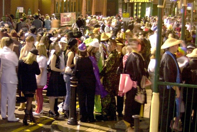 Thousands of revelers in fancy dress flood King Street for the annual event in 2003