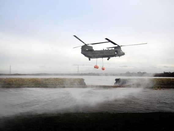 An RAF Chinook helicopter attempts to plug the gap in the defence wall