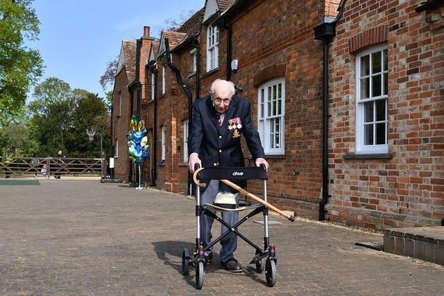 Captain Tom Moore celebrates his 100th birthday at home with his family after becoming a national hero by raising more than £32 million for the NHS by walking laps of his garden.