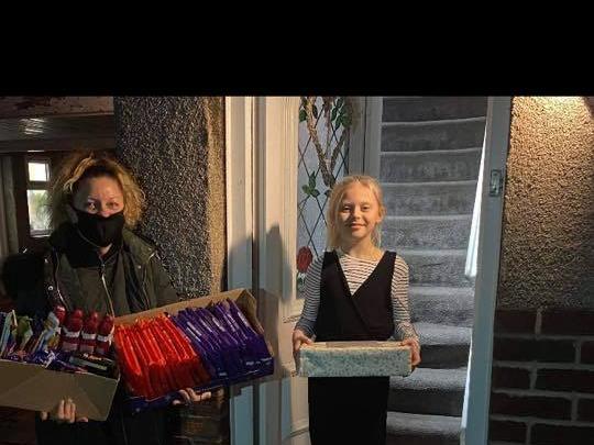 Filey community fridge receiving their donations from Ruby.
