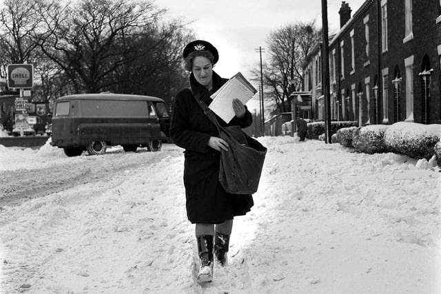 A postwoman delivers mail through the snow in Wigan during January 1967