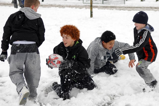 Where else in the world would you see this but Wigan?...Hardy youngsters from Norley Hall and Worsley Hall enjoy a game of rugby in the snow on Sherwood Drive, Wigna, January 2010.