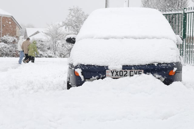 Cars are covered after heavy snowfall in Wigan, January 2010.