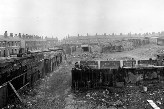 July 1951. View shows general disorder at an allotment on Clark Lane. Dirt tracks run past various wood and brick built structures. Houses on Temple View are visible on the left.