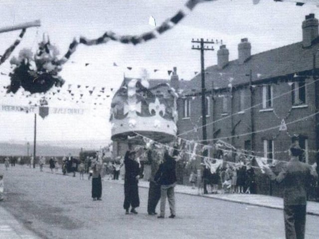 A large model of a crown being pulled into place during preparations for the celebrations for coronation of Queen Elizabeth II in June 1953. The view looks to the junction with Copperfield View.