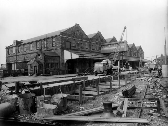 Work being carried out on a sewer under Hunslet Goods Depot on South Accommodation Road in August 1950. A trench is central, shored up with wooden beams and corrugated metal.