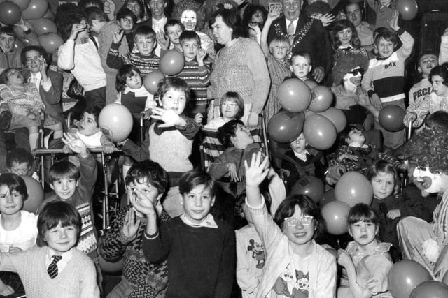 Clowns pub and Wigan's taxi drivers throw a Christmas party for local youngsters in Wigan during the 1980's