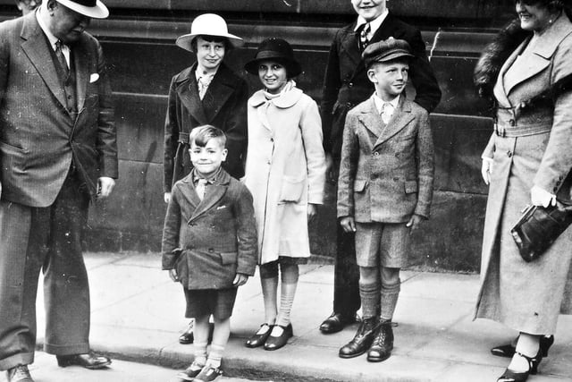 The Mayor of Morley, Coun Harold Smith, is seen with recipients of the Boots for the Bairns appeal in 1936, proudly showing off their new shoes.