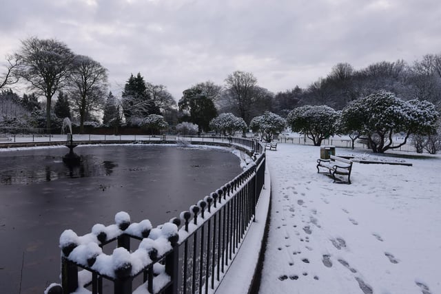 Partly frozen pond and fountain at Haigh Woodland Park