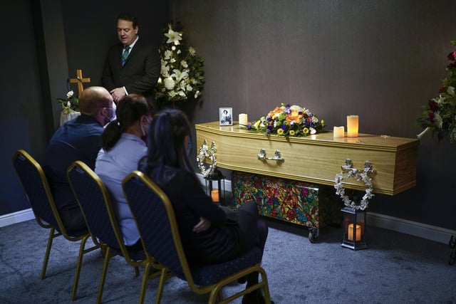 Relatives of Covid-19 victim Dennis Clapham attend his funeral service at Guardian Funerals in Shipley, West Yorkshire.