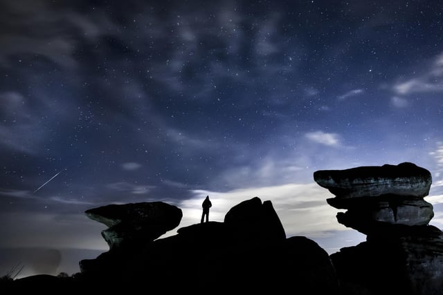 A man stargazing at Brimham Rocks in Yorkshire as the Orionid meteor shower reached its peak.