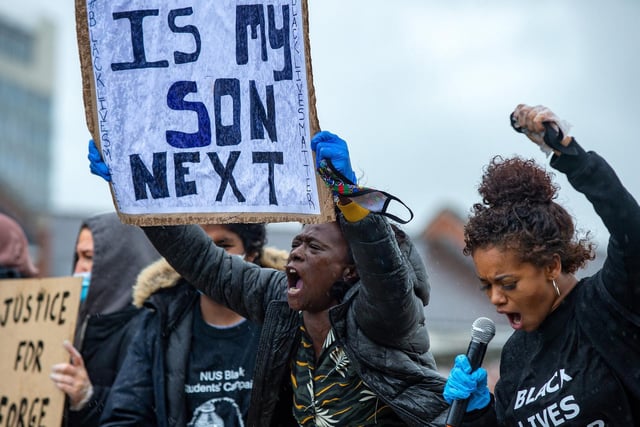 Woman holds up a poignant sign at a Black Lives Matter demonstration in Devonshire Green, Sheffield.