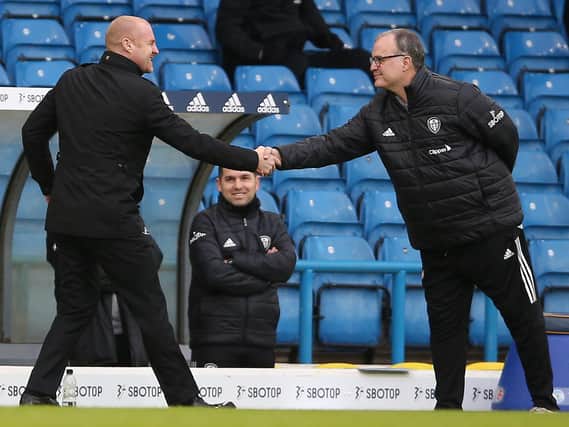 Burnley's English manager Sean Dyche (L) and Leeds United's Argentinian head coach Marcelo Bielsa (R) shake hands ahead of the English Premier League football match between Leeds United and Burnley at Elland Road on December 27, 2020.