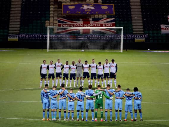 Both sets of players observe a minutes silence for all those lost in 2020.