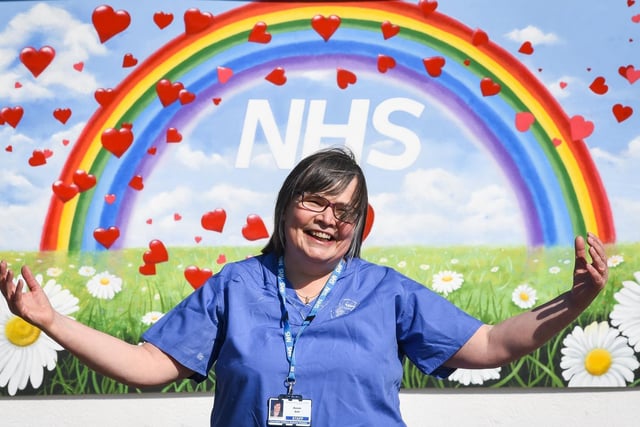 Dr Susan Salt, a former Blackpool Victoria Hospital nurse who left to work at Trinity Hospice before becoming a priest, returned to the hospital to help during the pandemic.  She is pictured in front of a rainbow which became a symbol of hope during the outbreak.