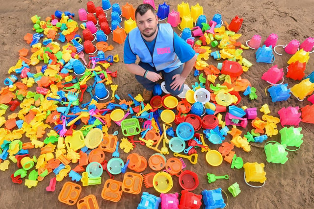 Steven King with some of the plastic toys which have been left on Blackpool beach over summer