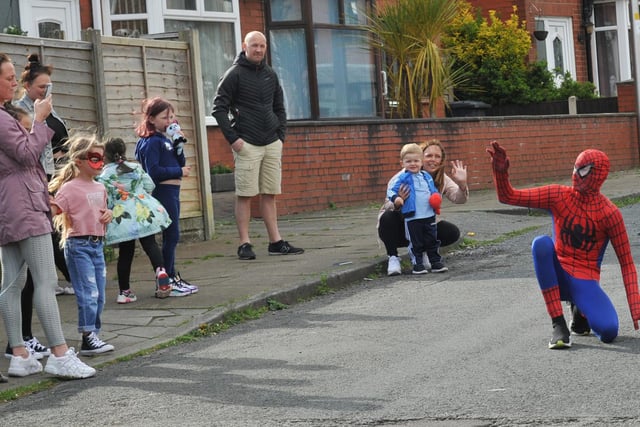 MAY - Wigan residents lined the streets to see Spiderman!  Behind the mask is 13-year-old McKenzie Fisher, he dressed as superhero Spiderman to cheer up children if they were celebrating their birthday during lockdown, performing flips and tricks, all the children were amazed.  Pictured on Vine Street, Whelley, Wigan, he also raised over £1,000 in donations for the NHS.