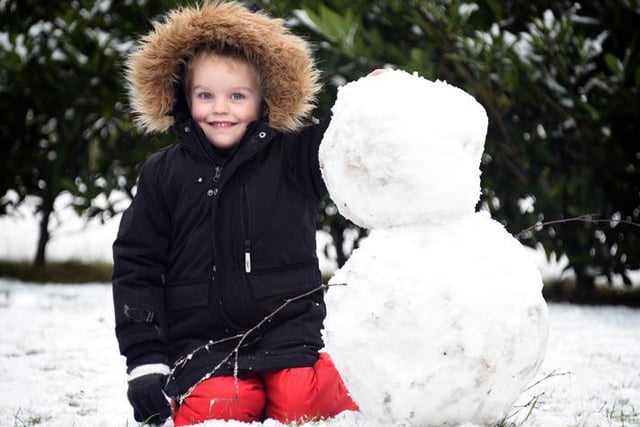 Six-year-old Leo Day with his snowman in Buckshaw Village