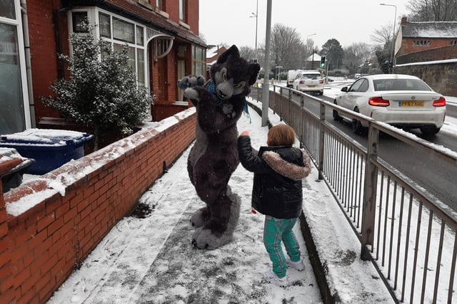 Fox in the snow: Children playing with a fancy-dress fox from Leyland business Winters Howling, who make mascot costumes
