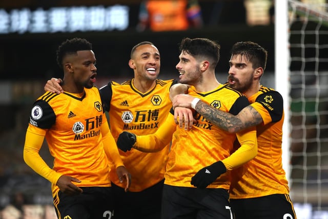 Pedro Neto of Wolves celebrates with teammates Nelson Semedo and Ruben Neves and Marcal after scoring during the Premier League match against Chelsea at Molineux on December 15, 2020.