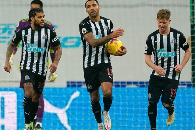 Callum Wilson of Newcastle United celebrates with DeAndre Yedlin and Matt Ritchie after scoring from the penalty spot during the Premier League match between Newcastle United and Fulham at St. James Park on December 19, 2020