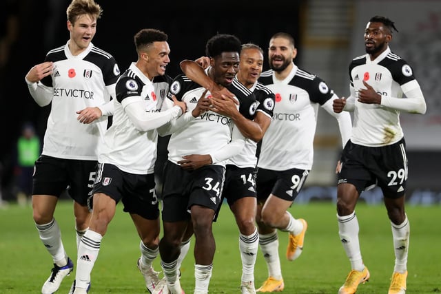 Ola Aina of Fulham is chased by the entire team as he celebrates scoring their 2nd goal during the Premier League match between Fulham and West Bromwich Albion at Craven Cottage on November 2, 2020 in London, United Kingdom.