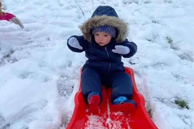 Reggie Dunleavy (two) enjoys his first sledging experience on Pendle Hill.