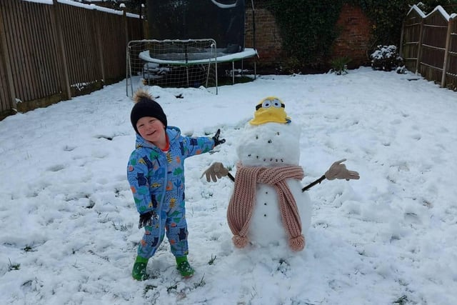 Riley Holden (three-and-a-half) with his snowman in Nelson