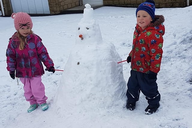 Emma and Tom Mitchell (four) were pleased with the snowman they built in Colne.