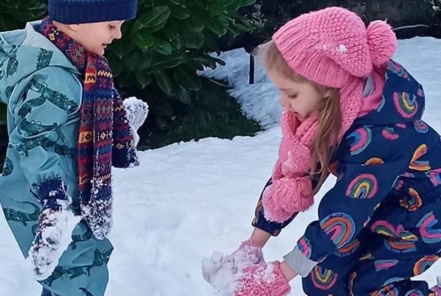 Do you want to build a snowman? Katie and John James Brock were captured playing together in the snow bhy Pamela Brock