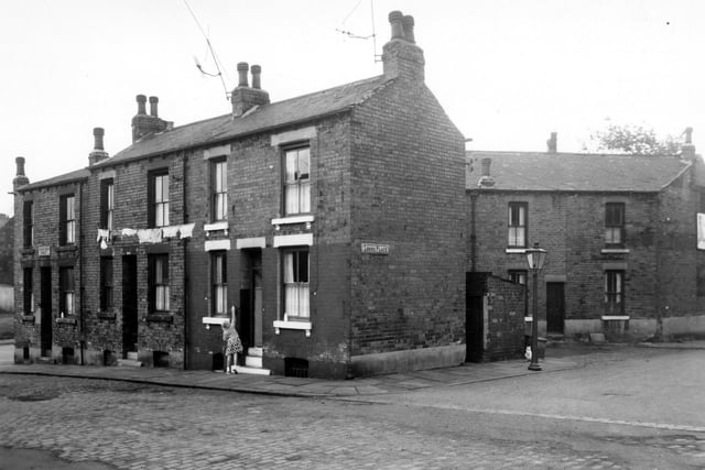 June 1963 and on the left is the corner of Crowther Street with Woodhouse Street. A child is adjusting the pulling line which is hung outside 5 with washing on it. Lorne Place is to the right.