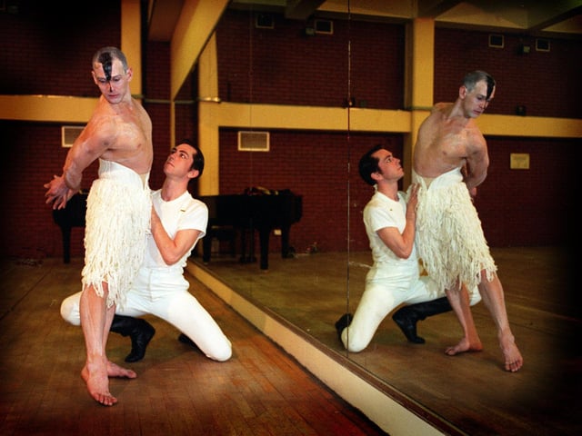 Dancers David Hughes,left, and Scott Ambler are reflected in the studio mirror at The Grand Theatre during the photo call for Swan Lake.
