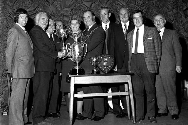 Hindley crown green bowlers line up with their haul of trophies at the annual presentation evening in 1973