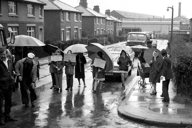 Determined protestors pictured with their placards staging a road block on  Laburnum Avenue, Ince, to demand a reduction of traffic through their housing estate in 1973