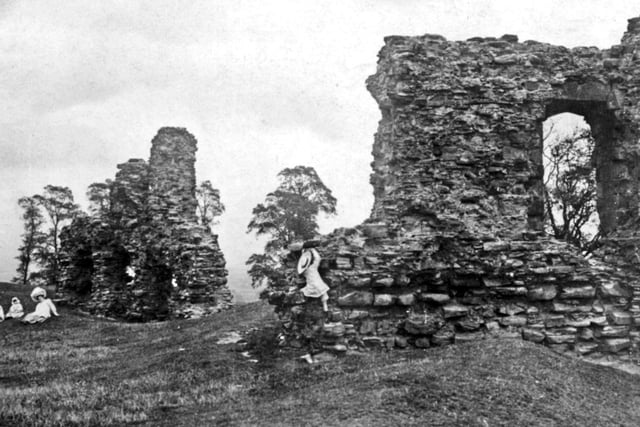 A young girl climbs on the castle ruins in this undated photo.