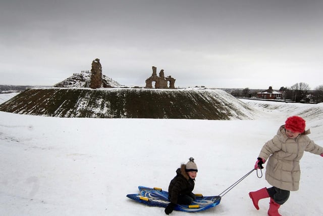 Charlotte, 9, pulls her brother James, 6, at the castle after a snowfall in January 2010.