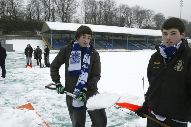 Fans of the Fax and FC Halifax Town dig in to clear snow and ice from the pitch at The Shay stadium, Halifax in 2010.