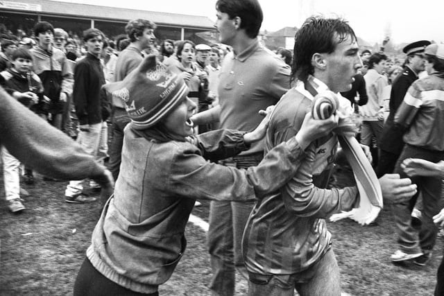 Wigan Athletic hat-trick hero Warren Aspinall is mobbed at the end of the match against Wolves in the final Division 3 match of the 1985/86 season at Springfield Park which Latics won 5-3 on Saturday 3rd of May 1986.
Steve Walsh and Graham Barrow scored the other two goals.