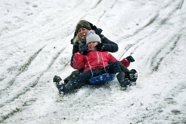 Russell Martin and his daughter Eva, 10, have fun in the snow in Roundhay Park, Leeds