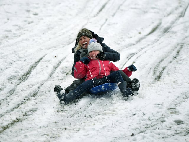 Russell Martin and his daughter Eva, 10, have fun in the snow in Roundhay Park, Leeds