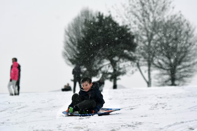 Eight-year-old Harry Bennett has fun in the snow in Roundhay Park
