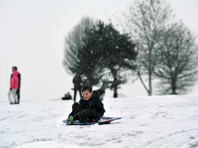 Eight-year-old Harry Bennett has fun in the snow in Roundhay Park
