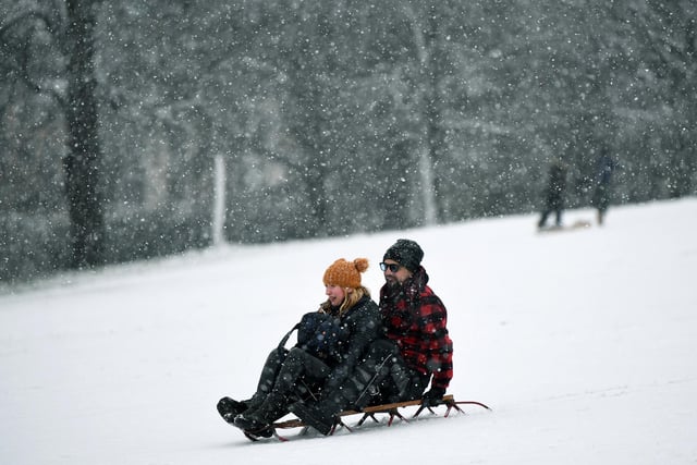 Odette Schofield and Bruno Stahl have fun in the snow in Roundhay Park, Leeds