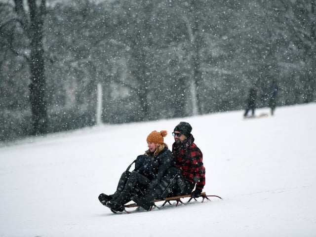 Odette Schofield and Bruno Stahl have fun in the snow in Roundhay Park, Leeds