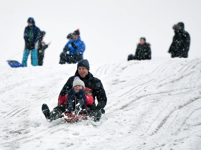Russell Martin and his daughter Eva, 10, have fun in the snow in Roundhay Park