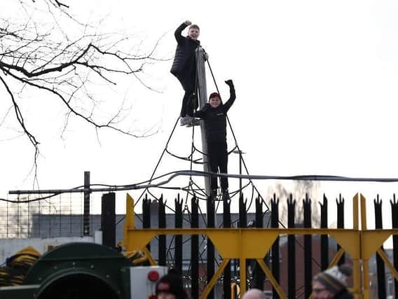 Young fans watch the action from the top of a nearby climbing frame during the FA Cup Third Round match between Chorley and Derby County at Victory Park