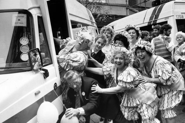 October 1986 and Roly Poly dance group member Mo Mighty Atom is helped on a new Micro Rider bus in Dortmund Square by drivers Harry Harrison and Selina Jenkinson.