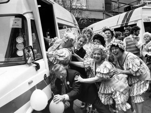 October 1986 and Roly Poly dance group member Mo Mighty Atom is helped on a new Micro Rider bus in Dortmund Square by drivers Harry Harrison and Selina Jenkinson.