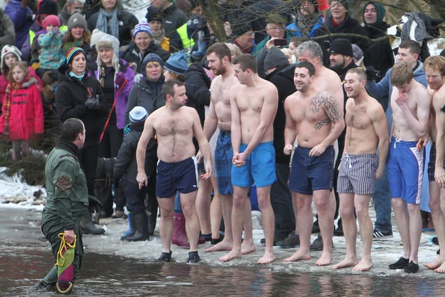 Men prepare to enter the water